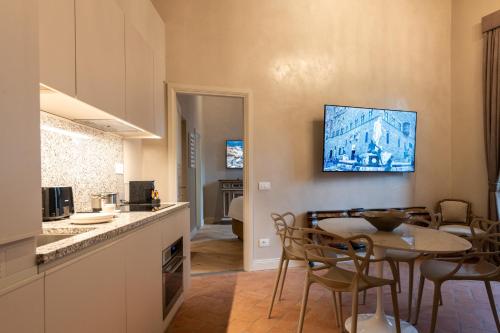 a kitchen and dining room with a table and chairs at Palazzo Doni by Florence Art Apartments in Florence