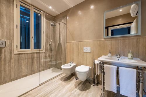 a bathroom with a toilet and a sink and a shower at Palazzo Doni by Florence Art Apartments in Florence