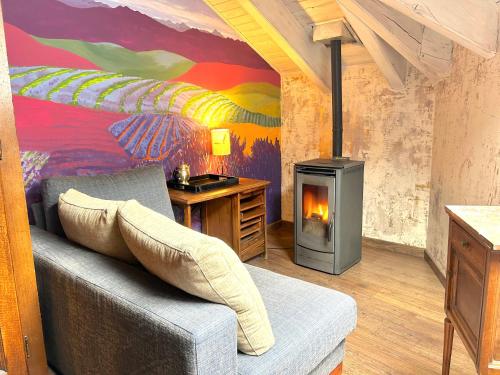 a living room with a couch and a fireplace at La Posada d'Àneu by RdA Hotels in Esterri d'Àneu