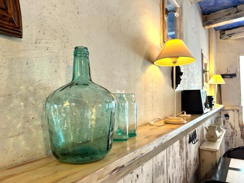 a green glass bottle sitting on top of a counter at La Posada d'Àneu by RdA Hotels in Esterri d'Àneu