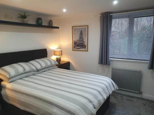 a bedroom with a large bed and a window at Home from home in Whitkirk