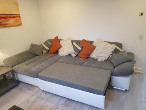 a couch with pillows on it in a living room at Home from home in Whitkirk
