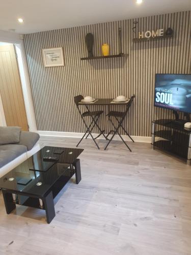 a living room with a couch and a table at Home from home in Whitkirk