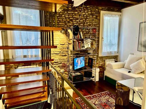 a living room with a couch and a television at Indipendent house in Venice in Venice
