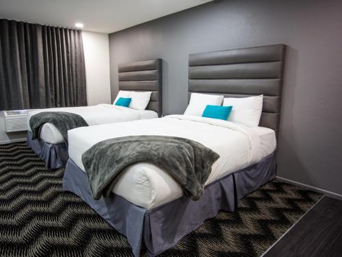 a hotel room with a bed and two nightstands at Siegel Select Convention Center in Las Vegas