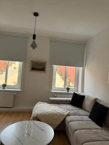a living room with a couch and two windows at Altstadtinsel am Johanneum in Lübeck