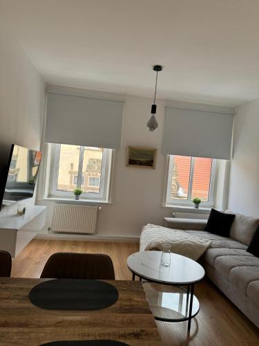 a living room with a couch and a table at Altstadtinsel am Johanneum in Lübeck