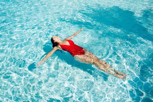 a woman laying in the water in the ocean at Virgin River Casino and Lodge in Mesquite