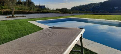 a swimming pool in the middle of a yard at Sunny Haven-Villa in Ponte de Lima