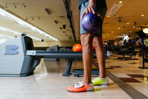 a man holding a bowling ball in a gym at Virgin River Casino and Lodge in Mesquite