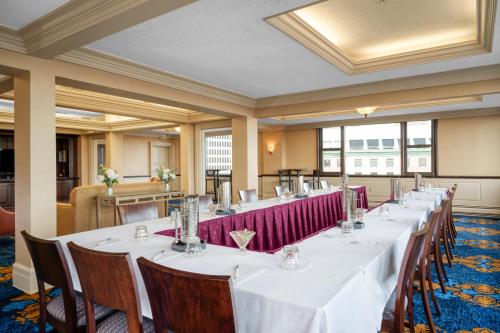 a row of tables in a large room with windows at Hampton Inn & Suites Providence Downtown in Providence