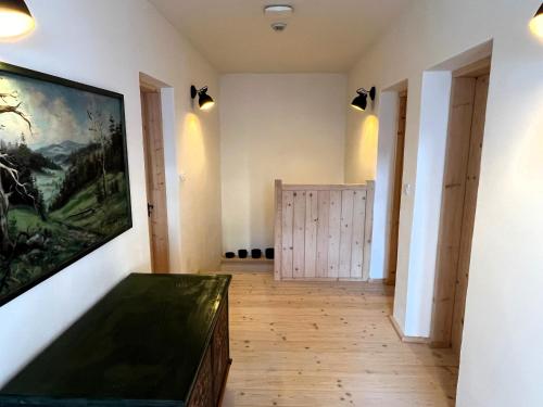 a room with a painting on the wall and a wooden floor at Velká chalupa na Panské in Jimramov