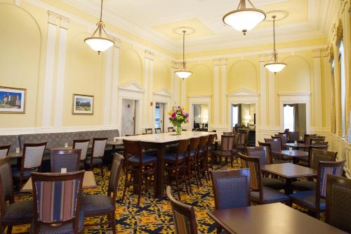 a dining room with tables and chairs and flowers at Hampton Inn & Suites Providence Downtown in Providence