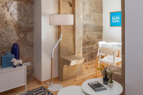 een woonkamer met een vloerlamp en een tafel bij Oporto Local Studios in Porto