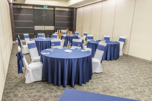 a conference room with blue tables and white chairs at Sheraton Quito in Quito