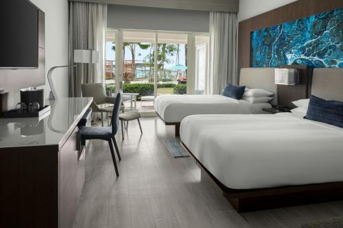 a hotel room with two beds and a desk at San Juan Marriott Resort and Stellaris Casino in San Juan