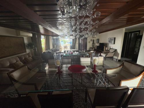 a dining room with a glass table and a living room at COP 30 - Apartamento Amplo in Belém