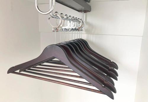 a bunch of utensils hanging from a rack in a kitchen at Komody in Delfoi