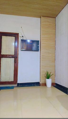 a room with a door and a plant in it at Unnati Guest House in Vrindāvan