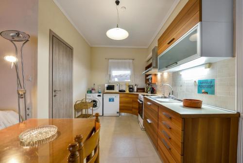 a kitchen with a sink and a counter top at Sophia houses by the sea in Nea Kalikratia