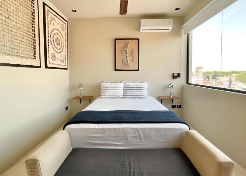 a bedroom with a bed and a large window at Mangle By Andiani in Cancún