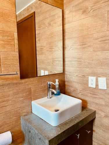 a bathroom with a white sink and a mirror at Loft Frente a la Playa!!!! in Boca del Río