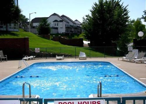 a large pool with blue water in a yard at Penthouse Thousand Hills Golf Front Condo with Pool close to 76 and Sleeps 8 in Branson