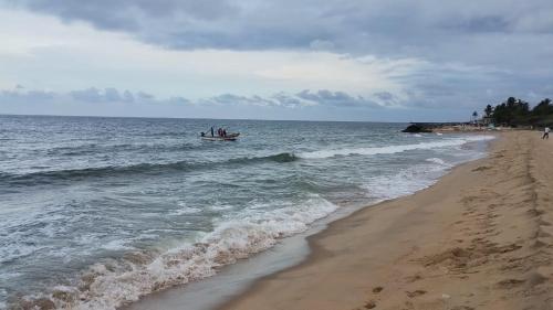 a group of people in a boat in the ocean at Dream Promenade Beach Side in Puducherry