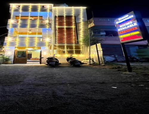 two motorcycles parked in front of a building at night at Dream Promenade Beach Side in Puducherry