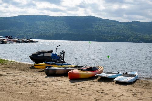 a group of boats on the shore of a lake at Scotty's Lakeside Resort in Lake George