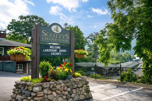 a sign for a library with flowers in front of it at Scotty's Lakeside Resort in Lake George