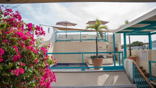 a balcony of a house with pink flowers at Posada La Fe in Cartagena de Indias