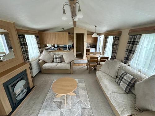 a living room with a couch and a table at 28 The Beeches in Wigton