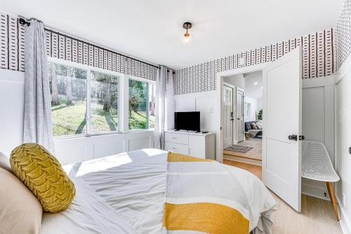 a bedroom with a bed and a large window at Waterfront Troy Home with Private Boat Dock! in Troy