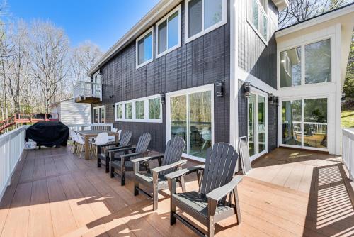 a house with chairs and tables on a deck at Waterfront Troy Home with Private Boat Dock! in Troy