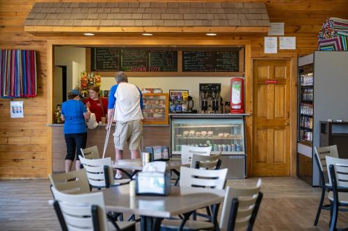 two people standing at a counter in a restaurant at Scotty's Lakeside Resort in Lake George
