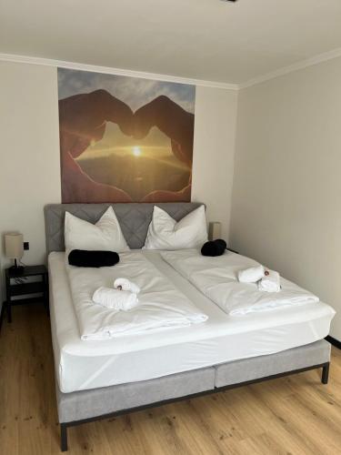 a white bed with two towels on top of it at Bergblick Appartements in Bad Gastein
