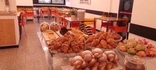 a bakery with many different types of pastries on display at Hotel Marbella in Cervia