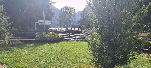 a park with a fence and a sign in the grass at Bioledro - Casa Lena in Mezzolago
