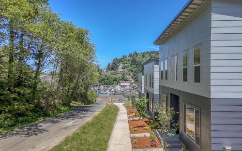 a house with a sidewalk next to a street at Harbor Lights 2 Family Fun Retreat Coastal Comfort in Depoe Bay