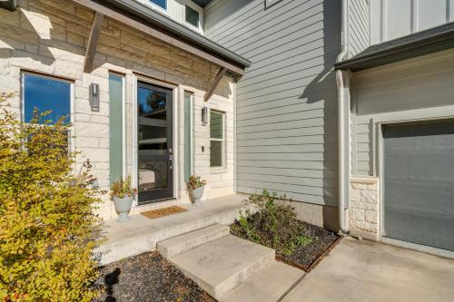 a front door of a house with two potted plants at 21 Mi to Dtwn Spacious Home in Austin Suburbs! in Austin