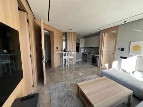 a living room with a couch and a table at TheBesty Ocean Suite -By Appart'Ayla in Anfa-Supérieur