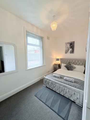a bedroom with a large bed and a window at Large Luxury Apartment Blackpool in Blackpool