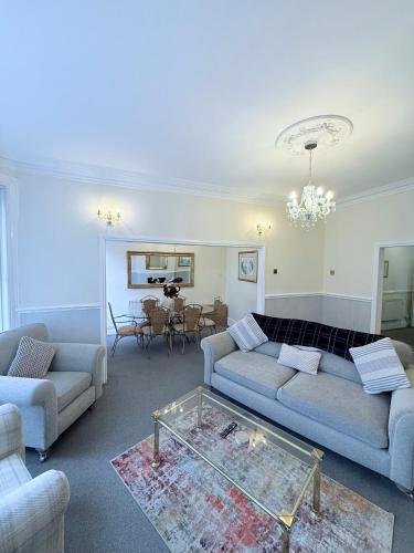 a living room with a couch and a table at Large Luxury Apartment Blackpool in Blackpool