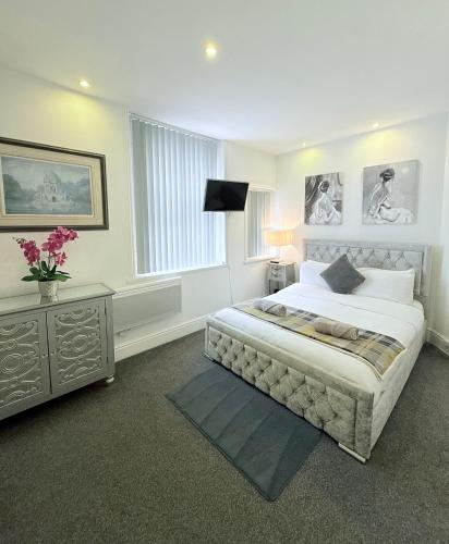 a bedroom with a large bed and a window at Large Luxury Apartment Blackpool in Blackpool