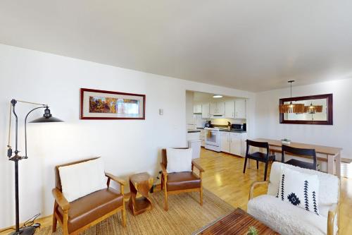 a living room with a table and chairs and a kitchen at Tensleep B11 in Teton Village
