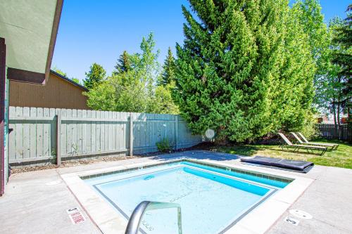 a swimming pool in a yard next to a fence at Tensleep B11 in Teton Village