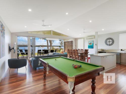 a living room with a pool table in it at Sunset Central Coast in Mannering Park