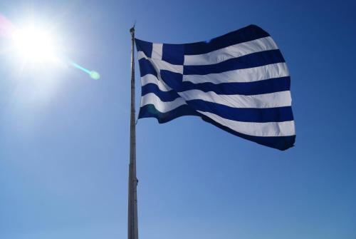 a flag on a pole with the sun in the background at "Apeiros Chora" Hotel, Zagori in Kato Pedina