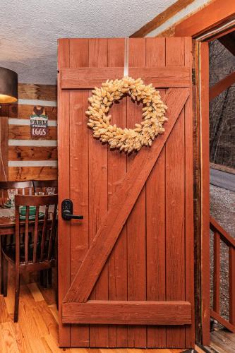 a wooden door with a wreath on it at Whiskey Run Cabin, Spectacular Mountain Views in Bryson City